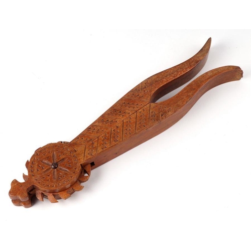 205 - A 19th century treen cotton winder in the form of a shoe, 7cms long; together with a carved treen nu... 