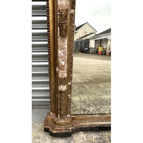 2190 - A large Victorian arch topped giltwood and gesso overmantle mirror with original ceramic bun feet an... 