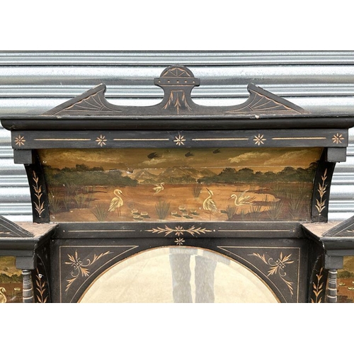 2194 - An Aesthetic Movement ebonised overmantle mirror, the panels hand painted with river scenes and eagr... 