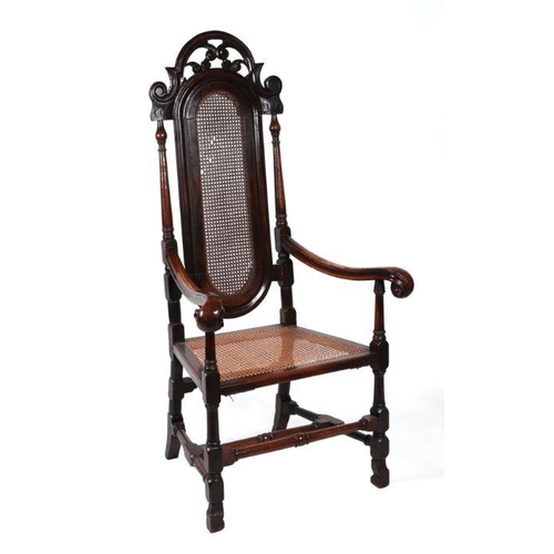 2195 - A 17th century William & Mary walnut open armchair with cane work back and seat, scroll arms and... 