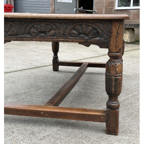 2199 - A large 17th century style oak refectory table with carved frieze, on turned bulbous carved legs joi... 