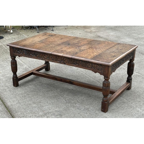 2199 - A large 17th century style oak refectory table with carved frieze, on turned bulbous carved legs joi... 