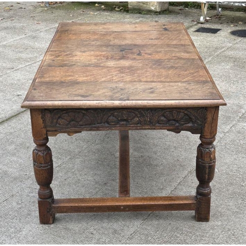 2199 - A large 17th century style oak refectory table with carved frieze, on turned bulbous carved legs joi... 