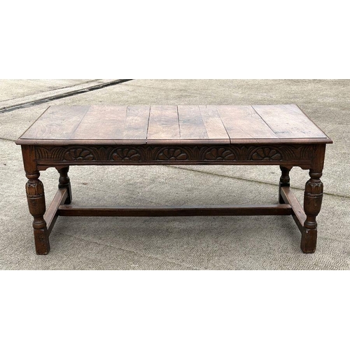 2199 - A large 17th century style oak refectory table with carved frieze, on turned bulbous carved legs joi... 