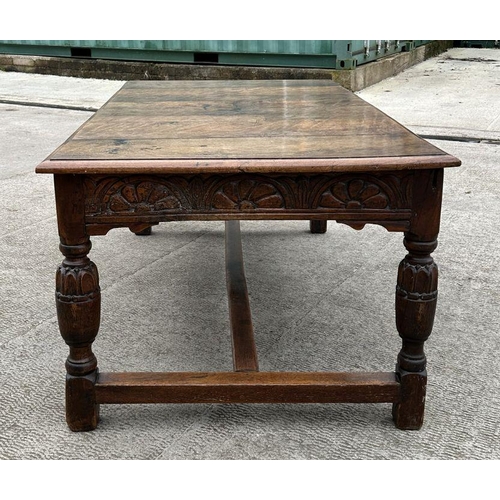 2199 - A large 17th century style oak refectory table with carved frieze, on turned bulbous carved legs joi... 