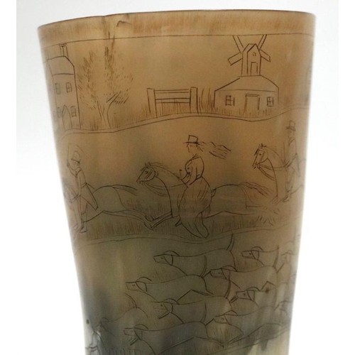 232 - A horn beaker decorated with a fox hunting scene, 14cms high.