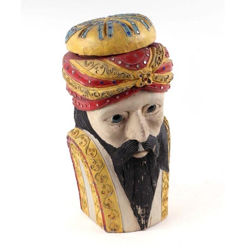 244 - A carved and polychromed wooden box and cover in the form of a bearded Turkish man, 34cms high.