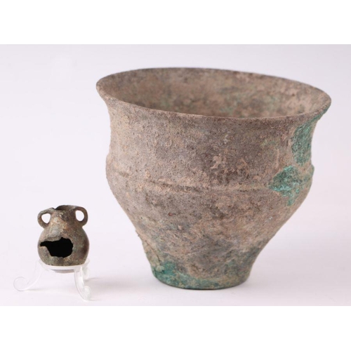 258 - An ancient Roman large bronze vessel, 12cms high; together with a bronze oil lamp with horse head ha... 