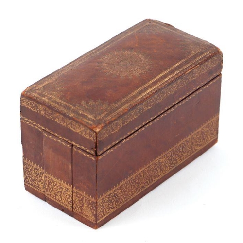 273 - A tooled leather cigarette box with fitted interior, 14cms wide.