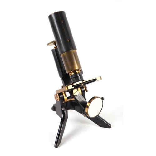 278 - A Victorian lacquered brass monocular microscope, cased; together with a selection of lenses.