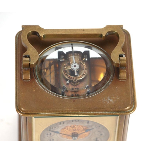 293 - A brass cased carriage clock, the silvered dial with Arabic numerals, the movement striking on a gon... 