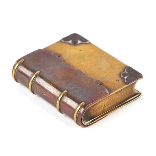 60 - A WW1 trench art lighter in the form of a miniature book, made from brass and copper. 5.5cms (2.125i... 