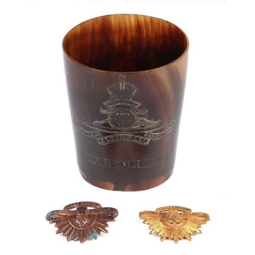 93 - Military interest.  A horn beaker engraved 'Gallipoli 1915' and Australian badges, 9cms high; togeth... 