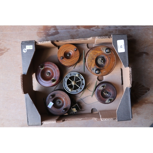 35 - A group of vintage fishing reels to include a Starback example.