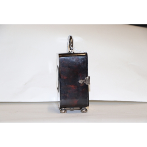 303 - A silver mounted tortoiseshell carriage time piece on bun feet with scroll handle, London 1920, 9cms... 