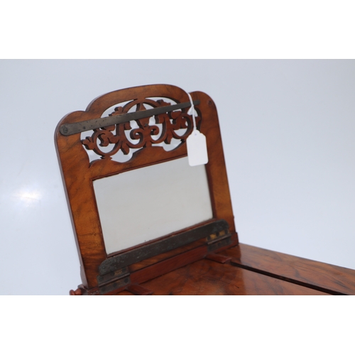 283 - A Victorian figured walnut stereoscopic table top card viewer, 61cms long.