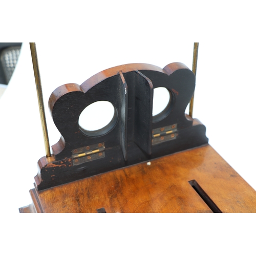 283 - A Victorian figured walnut stereoscopic table top card viewer, 61cms long.