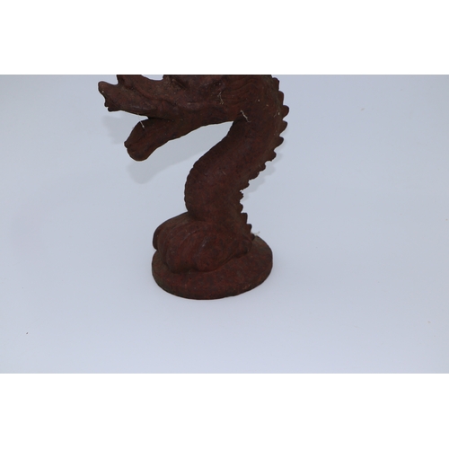 228 - A large well weathered Chinese style iron dragon head doorstop / finial, 35cms high.