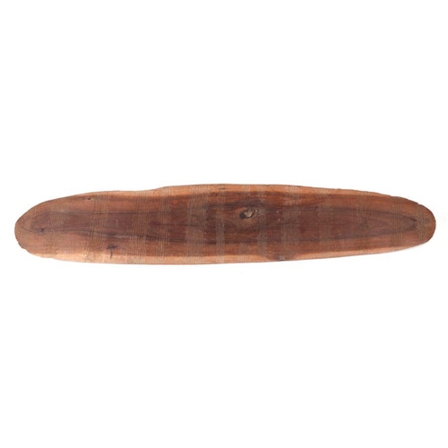 131 - An Australian Aboriginal wooden shield with incised decoration to front and rear, 75cms long.