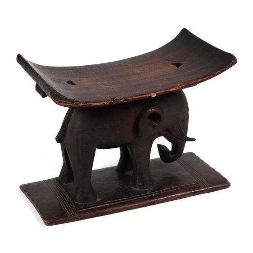 132 - African / Tribal Art.  An Ashanti hardwood stool on elephant support, 50cms wide.