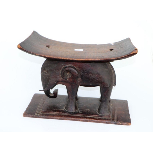 132 - African / Tribal Art.  An Ashanti hardwood stool on elephant support, 50cms wide.