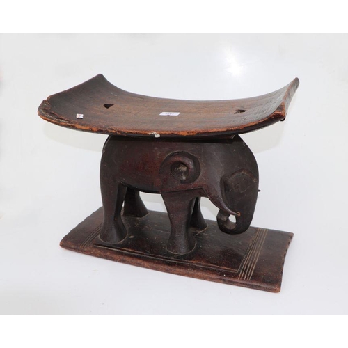 132 - African / Tribal Art.  An Ashanti hardwood stool on elephant support, 50cms wide.