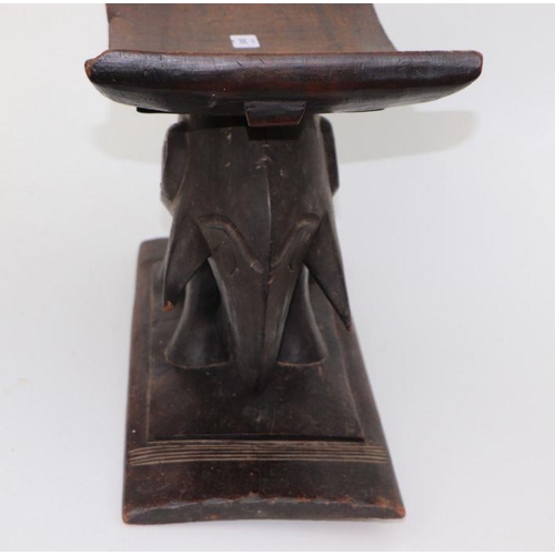 132 - African / Tribal Art.  An Ashanti hardwood stool on elephant support, 50cms wide.