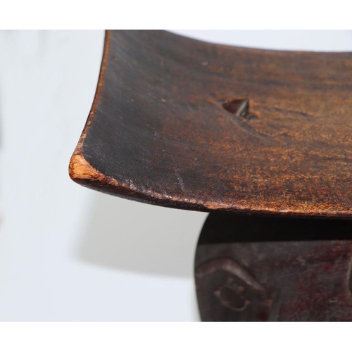 132 - African / Tribal Art.  An Ashanti hardwood stool on elephant support, 50cms wide.