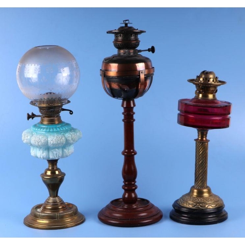 151 - Two Victorian oil lamps; together with a copper oil lamp on a mahogany stand (all a/f) (3).