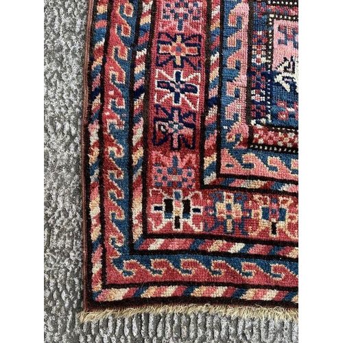 165 - A West Turkmenistan Tekke rug with a field of aina kochak guls, 164 by 244cms.