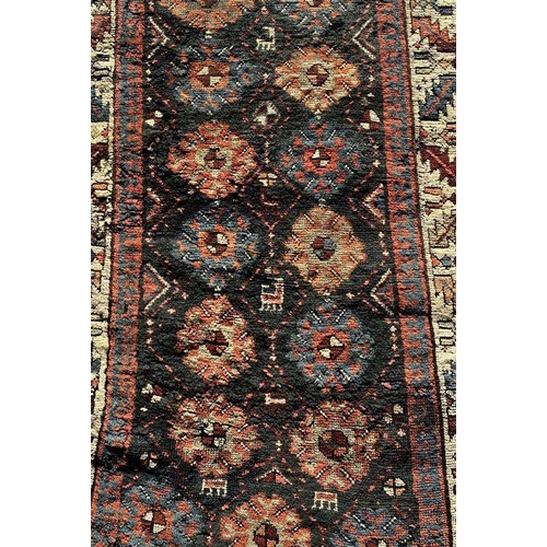 170 - A Persian hand knotted runner, the central medallions on a blue ground within a multi border, 419 by... 