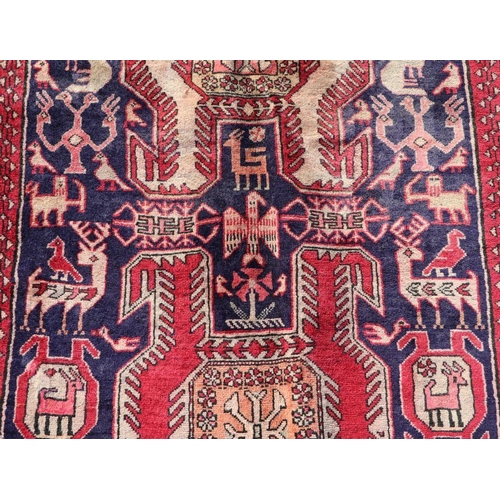 188 - A Persian Azari hand knotted woollen runner with stylised animals and bird motifs on a beige ground,... 