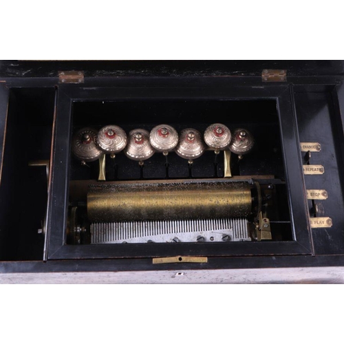 26 - A late 19th century Swiss cylinder music box playing eight airs striking on seven bells, 54cms wide.