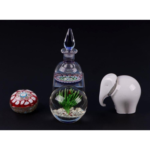 307 - A group of glass paperweights to include millefiori scent bottle and a Wedgwood style elephant (4).