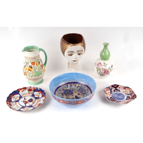 355 - A mixed lot of ceramics to include a Charlotte Rhead jug, Derby cups and saucers, Chameleon ware bow... 