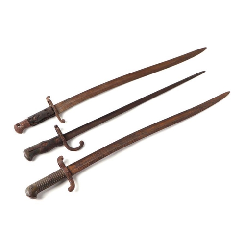 50 - A 19th century French bayonet with 52cms steel blade; together with two other bayonets (3).