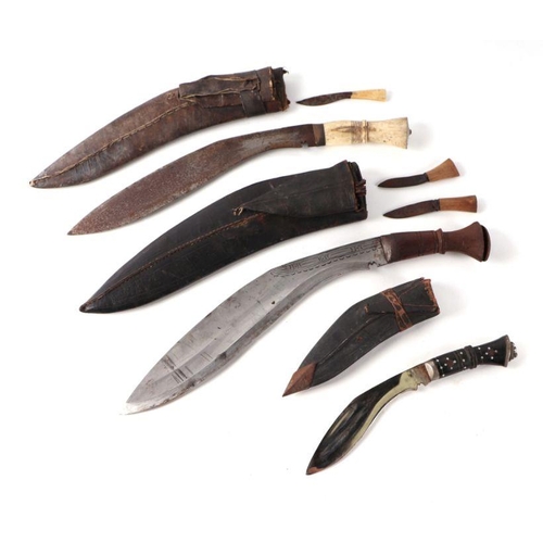 54 - A Kukri with bone handle and leather scabbard, 40cms long; together with two similar (3).