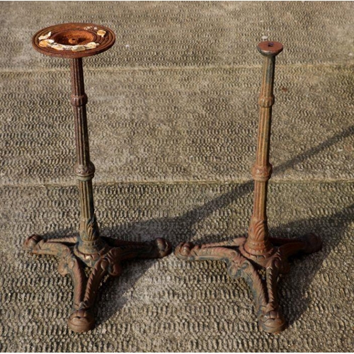 6 - A pair of cast iron garden table bases, 68cms high (2).