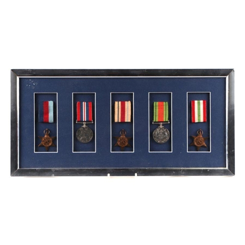 63 - A WWII medal group to include the Africa star and the Italy star. mounted in a display frame.