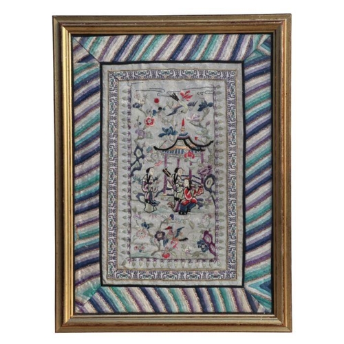 733 - A Chinese silk embroidered panel depicting figures in a garden, framed & glazed, 30 by 43cms.