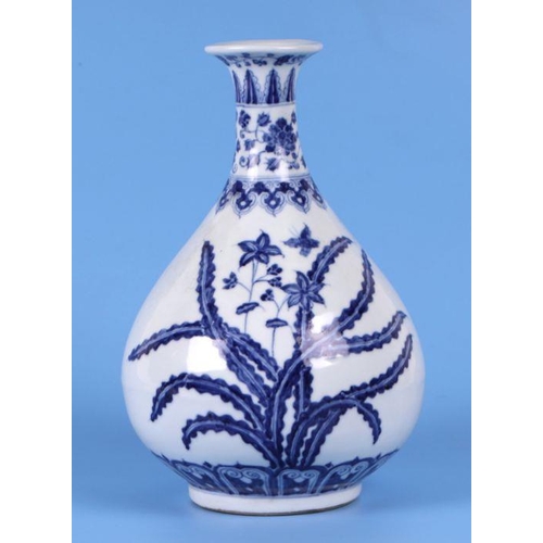 736 - A Chinese blue & white vase decorated with flowers and foliage, 25cms high.