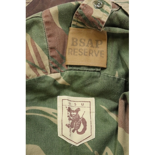 98 - A Rhodesian BSAP Reserve camouflage uniform and various Rhodesia Army cloth badges.