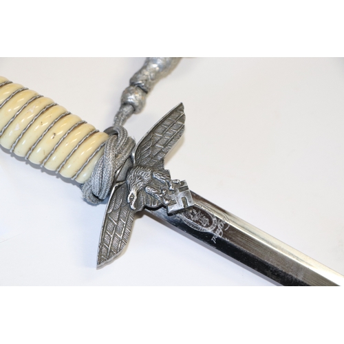 106 - A replica Nazi dress dagger, the blade marked 'Solingen Waffen' in scabbard, 43cms long.