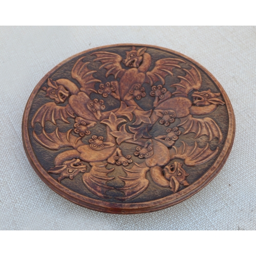 126 - A carved wooden platter, 32cms wide; together with others similar (5).