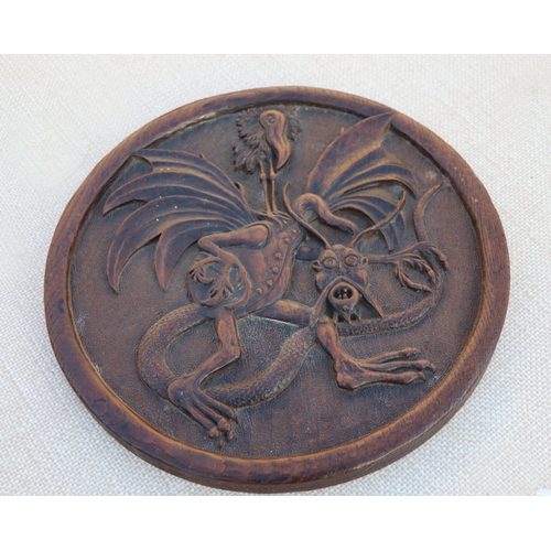 126 - A carved wooden platter, 32cms wide; together with others similar (5).