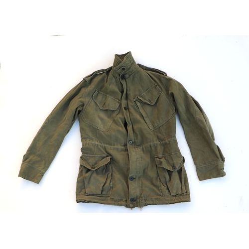 97 - A quantity of assorted military uniform to include winter jackets and other similar items.