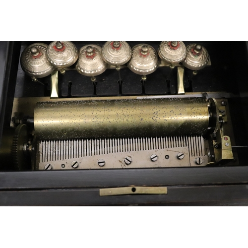 26 - A late 19th century Swiss cylinder music box playing eight airs striking on seven bells, 54cms wide.