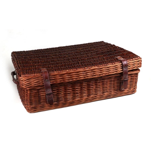 123 - An early 20th century Coracle wicker picnic basket with red Retsine interior, leather carrying handl... 