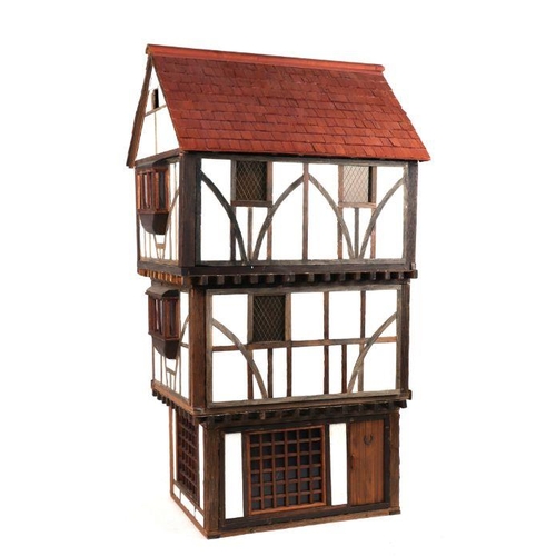 125 - A three storey Tudor style doll's house based on a National Trust owned timber framed and jettied ho... 