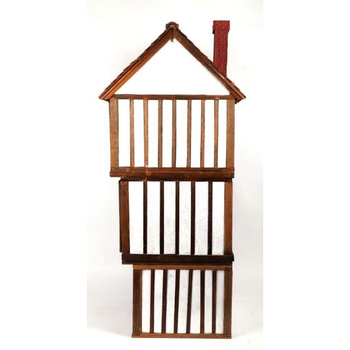 125 - A three storey Tudor style doll's house based on a National Trust owned timber framed and jettied ho... 